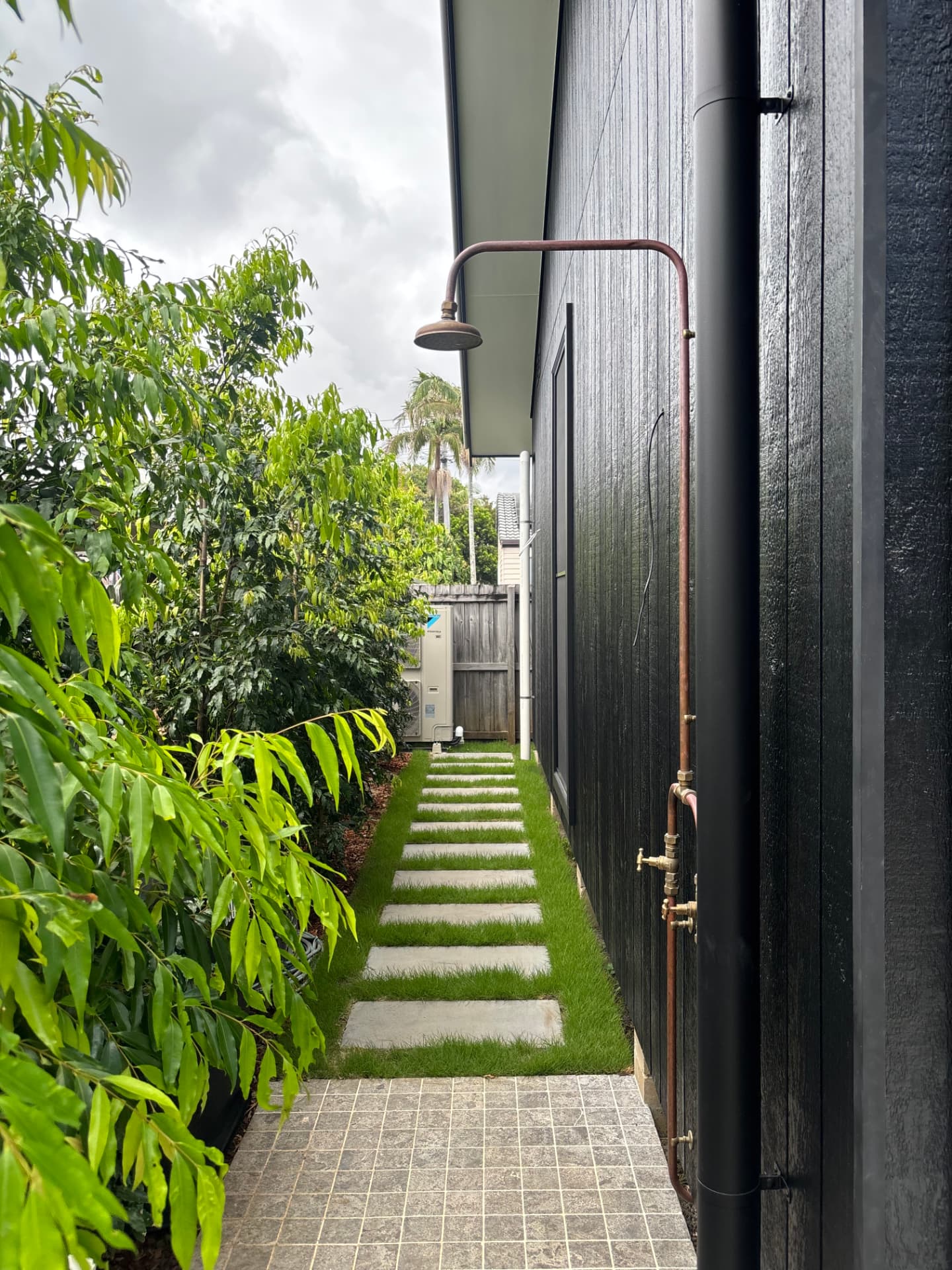 Andrew Place copper outdoor shower on charred timber cladding