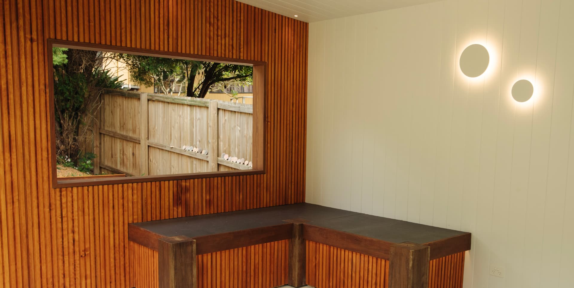 Timber batten wall with built-in daybed seating in daylight